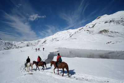 People riding horses on mountain