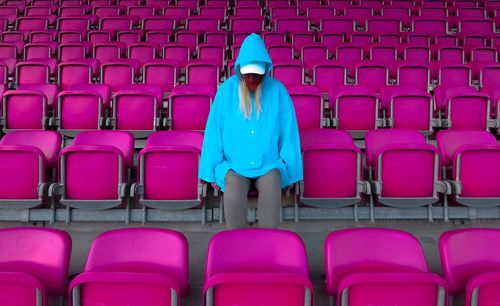 Full length of young woman sitting on chair