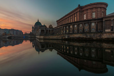 Reflection of building in lake at sunset