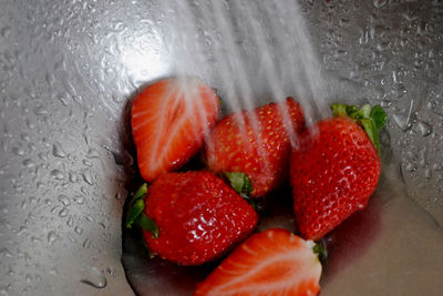Water splashing on strawberries in bowl