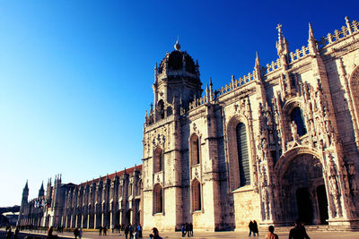 Low angle view of building against clear blue sky