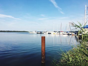 View of boats moored in calm blue sea