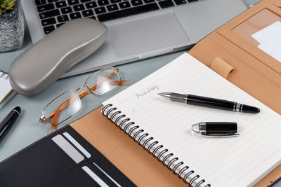 High angle view of laptop and book on table