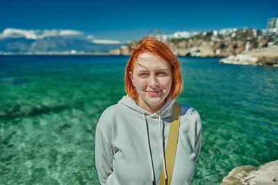 Portrait of smiling woman at beach