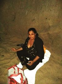 Portrait of a smiling young woman sitting outdoors