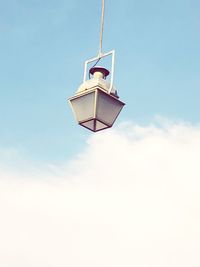 Low angle view of gas light hanging against sky