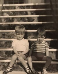 High angle view of boy sitting on staircase