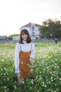 Young woman standing on field