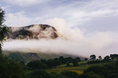 Scenic view of mountains against cloudy sky