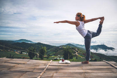 Woman doing yoga on observation point