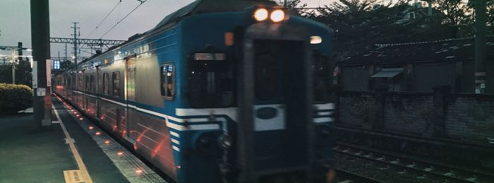Train on railroad station platform at dusk