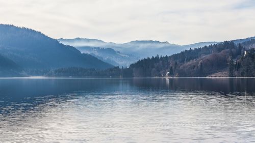 Scenic view of lake and mountains against sky