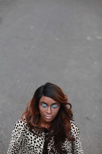 Young woman with eye make-up on road