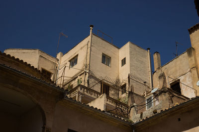 Low angle view of buildings against clear sky