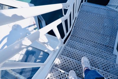 Low section of person standing on railing