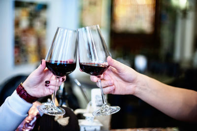 Midsection of people drinking glass