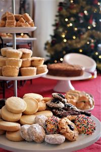 Close-up of cookies on table with christmas tree in background 