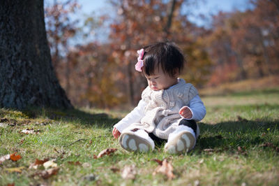 Cute girl sitting on grass