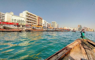 View of buildings by sea against clear sky