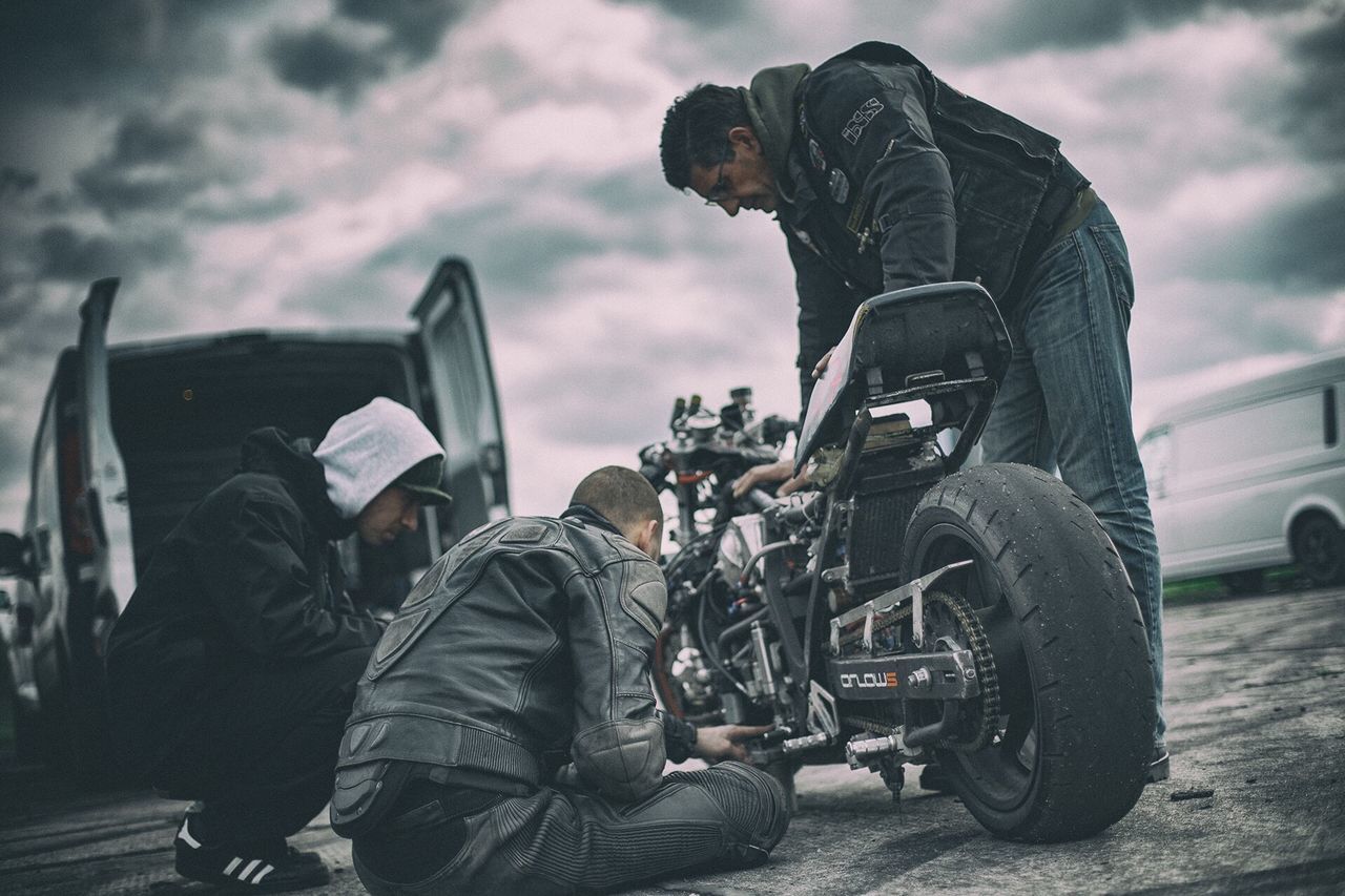 men, sky, lifestyles, transportation, leisure activity, land vehicle, mode of transport, cloud - sky, rear view, person, photographing, sitting, photography themes, travel, casual clothing, camera - photographic equipment, car, cloud