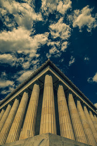 Low angle view of historical building against cloudy sky