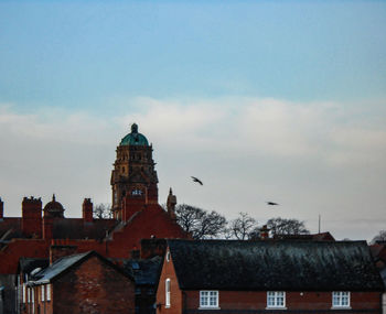 Buildings in city against sky