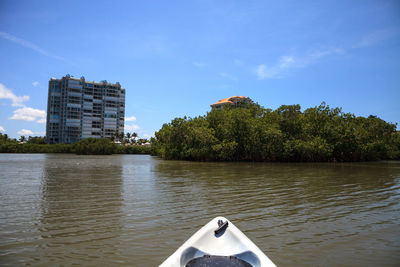 Scenic view of river by trees against sky