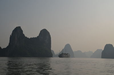 Scenic view of sea and mountains against sky