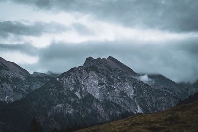 Scenic view of mountains against cloudy sky