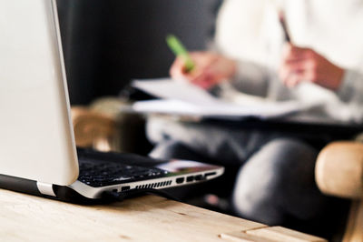 Businessman working while laptop on table at office