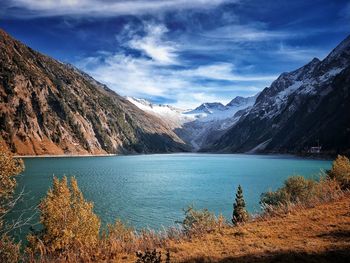 Scenic view of lake and mountains against sky