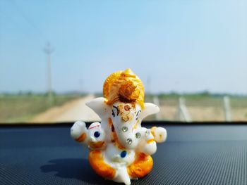 Close-up of stuffed toy on table against sky