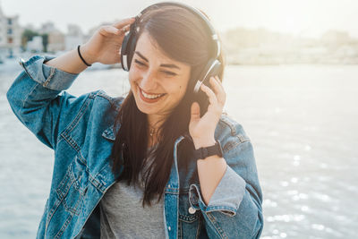 Portrait of young woman using mobile phone outdoors