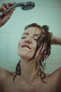 Portrait of shirtless man in bathroom