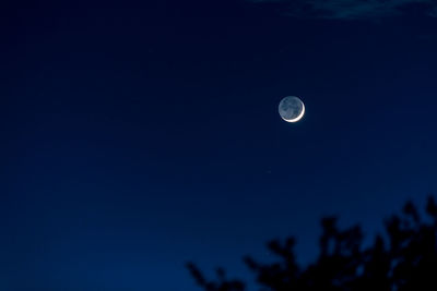 Low angle view of moon against sky at night