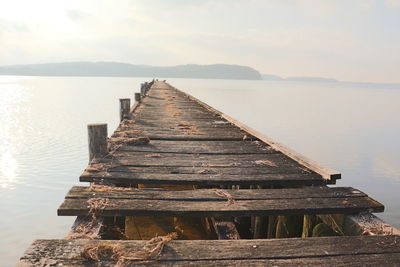 Pier over lake against sky