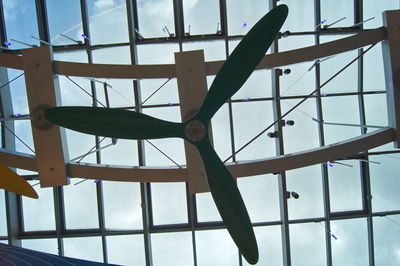 Low angle view of person against sky seen through window