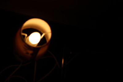 Close-up of illuminated lamp in darkroom