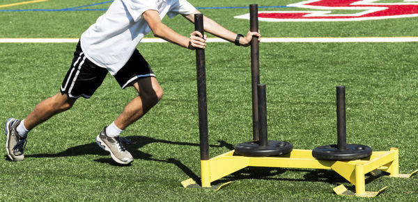 Low section of men playing with ball