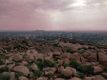 Aerial view of city against cloudy sky