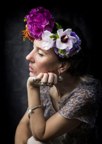 Woman with flowers on her head recalling the style of frida iv