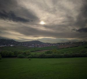 Scenic view of landscape against cloudy sky