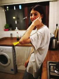 Portrait of young woman at home