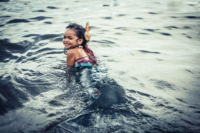 Portrait of smiling girl swimming in sea