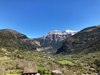 Scenic view of mountains against clear blue sky