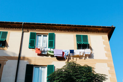 Low angle view of building against clear blue sky