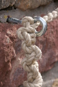 Close-up of rope and hook on wall