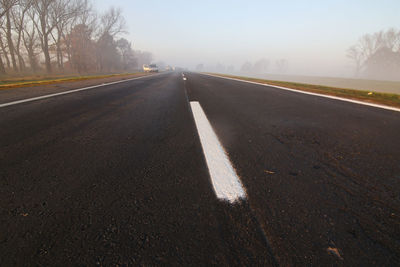 Surface level view of country road against sky