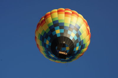 Low angle view of hot air balloon against clear blue sky