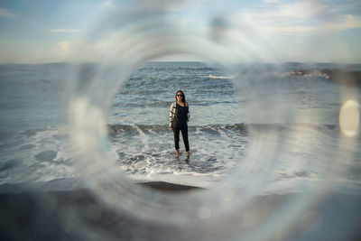 Woman standing on sea shore